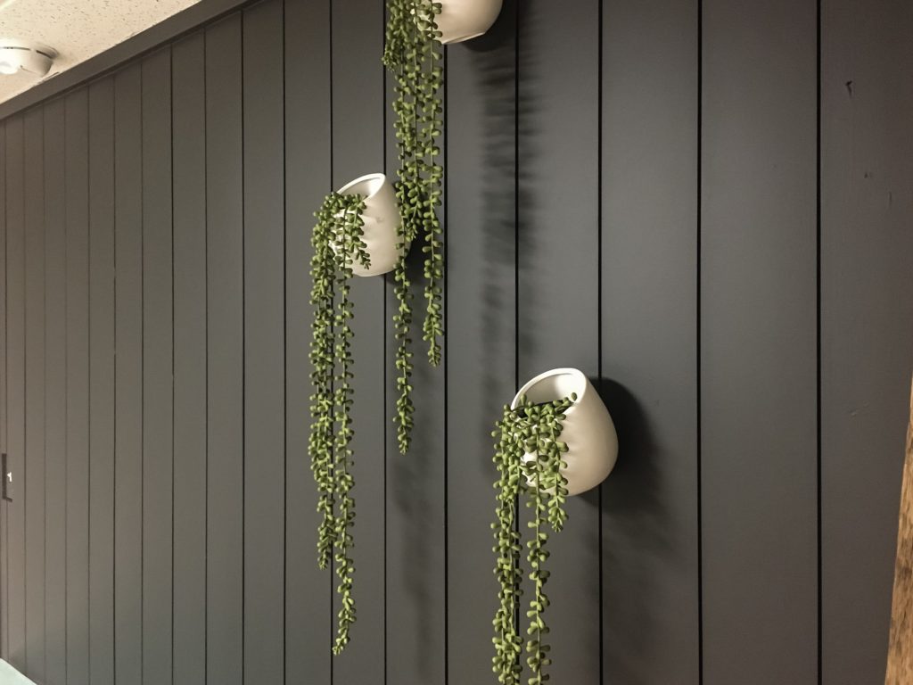 Create depth in a small space with this vertical shiplap wall in Tricorn Black by Sherwin Williams