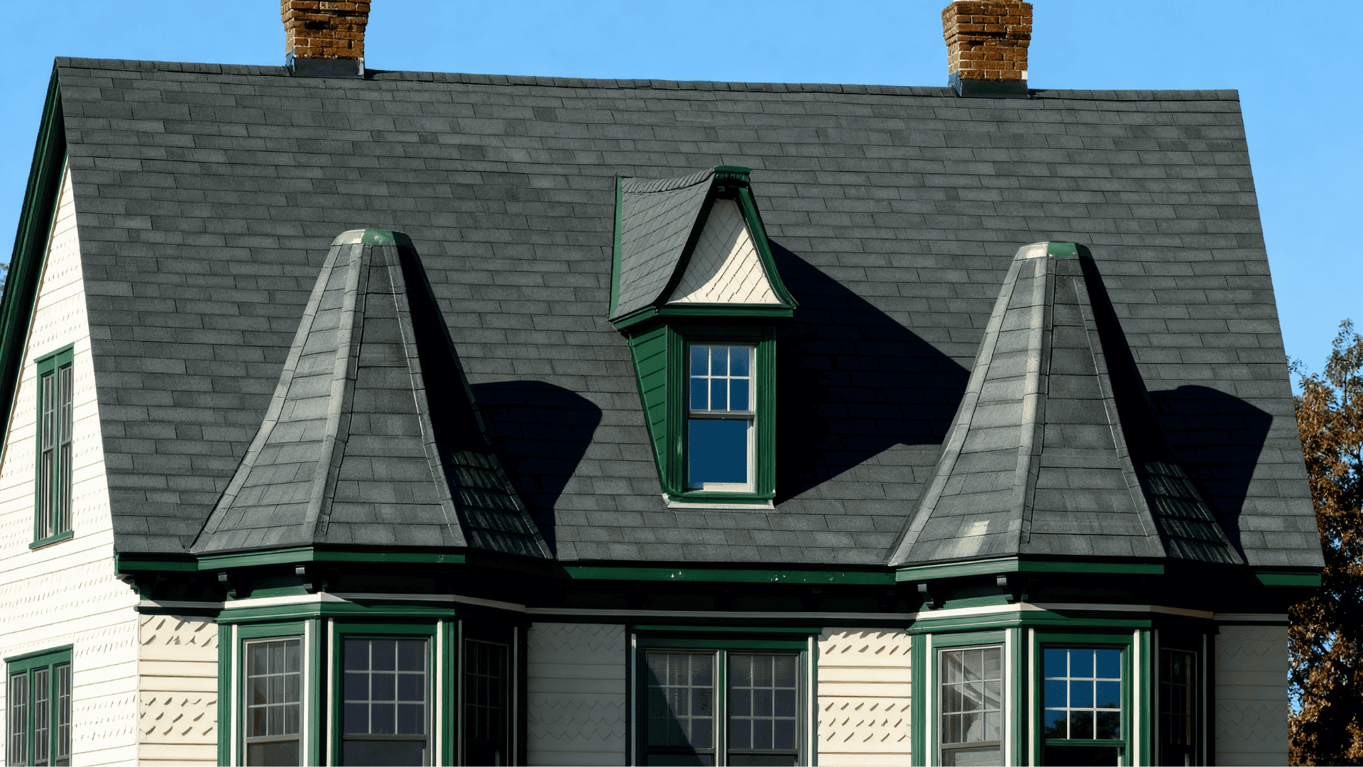 Dormer bay windows with angled sides on a Victorian-style residential roof