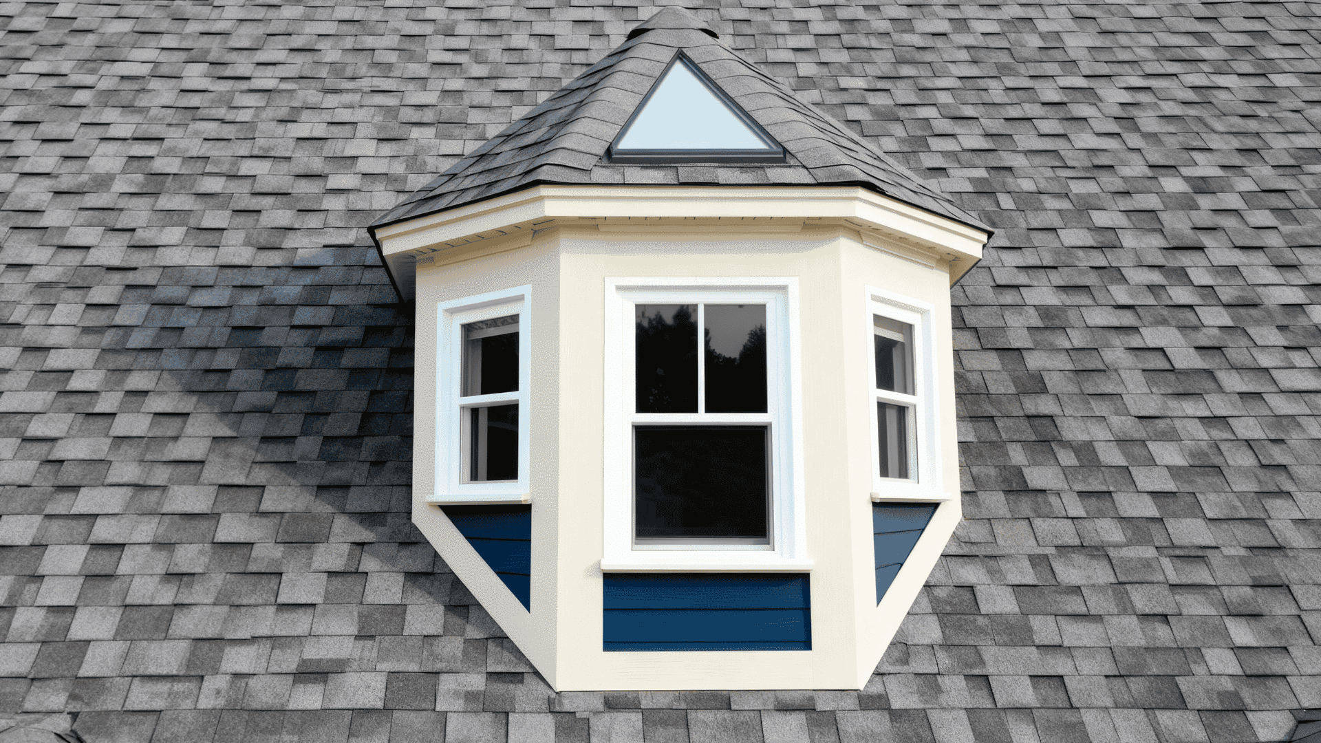 Modern dormer bay with side windows and a pyramid-shaped roof design