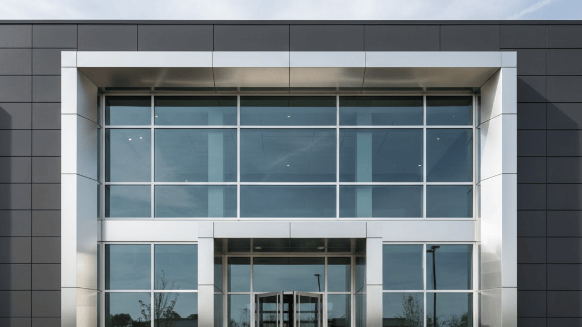 Modern commercial building with metal clad exterior window trim and large glass facade design