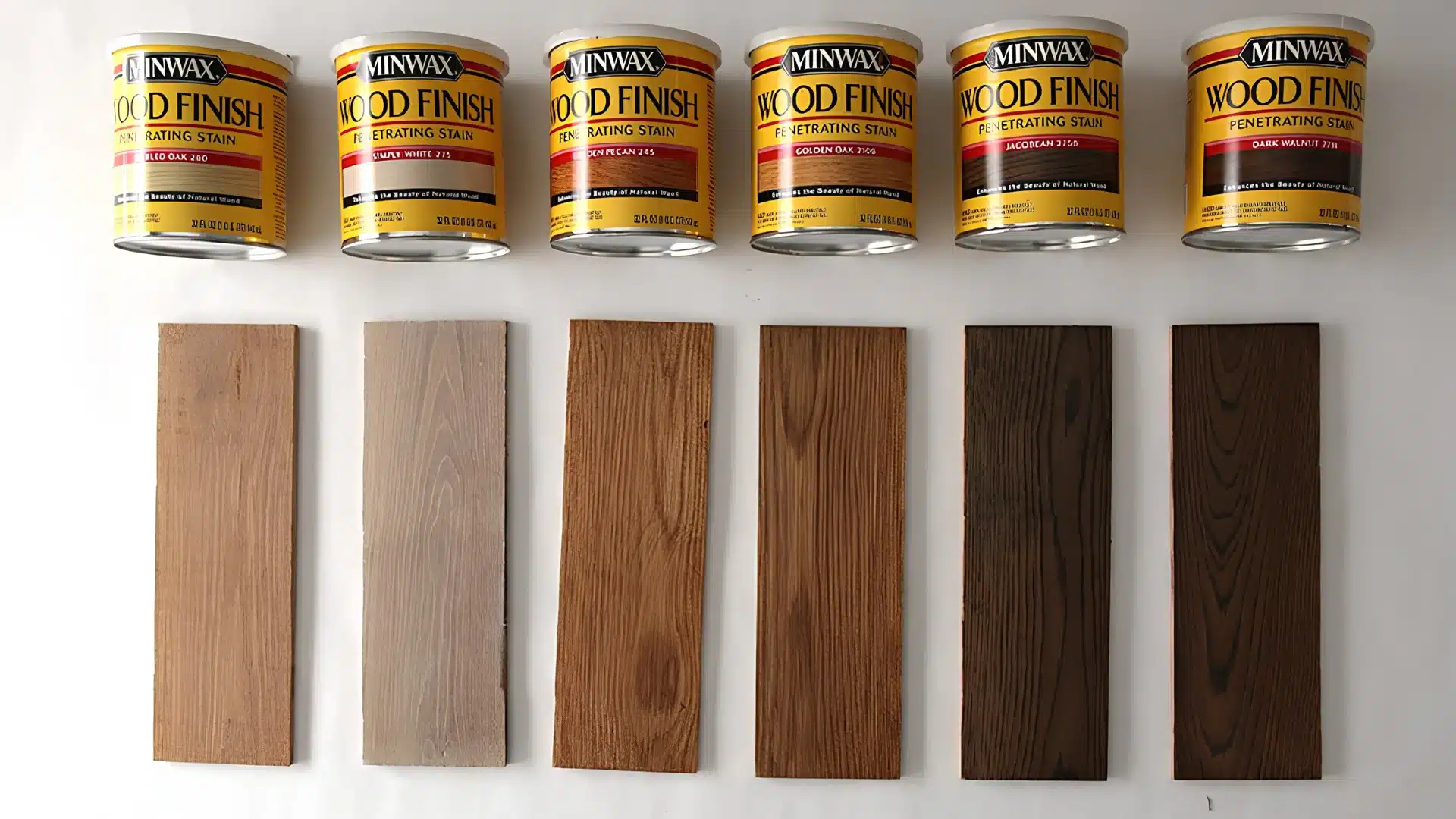 Six cans of Minwax stain with corresponding wood samples showing different color applications