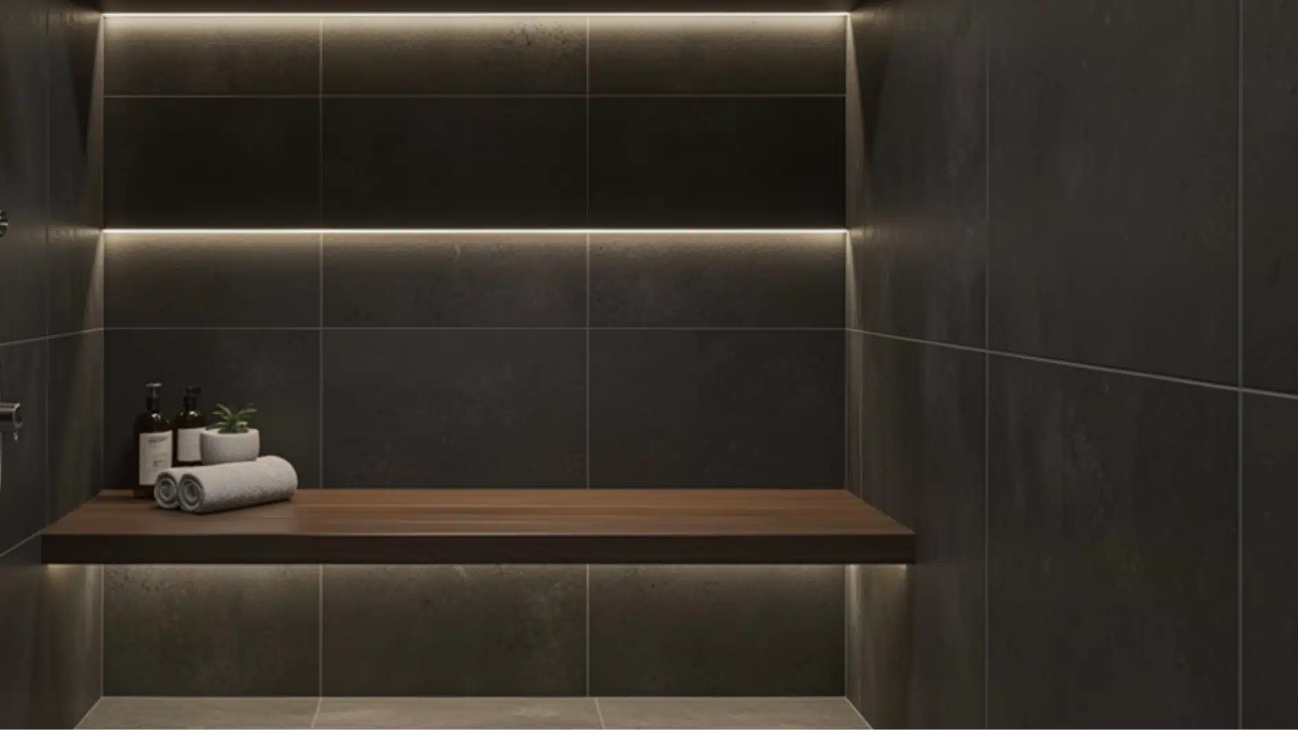 Modern dark tiled shower niche featuring a floating wooden bench illuminated by hidden LED strip lighting.