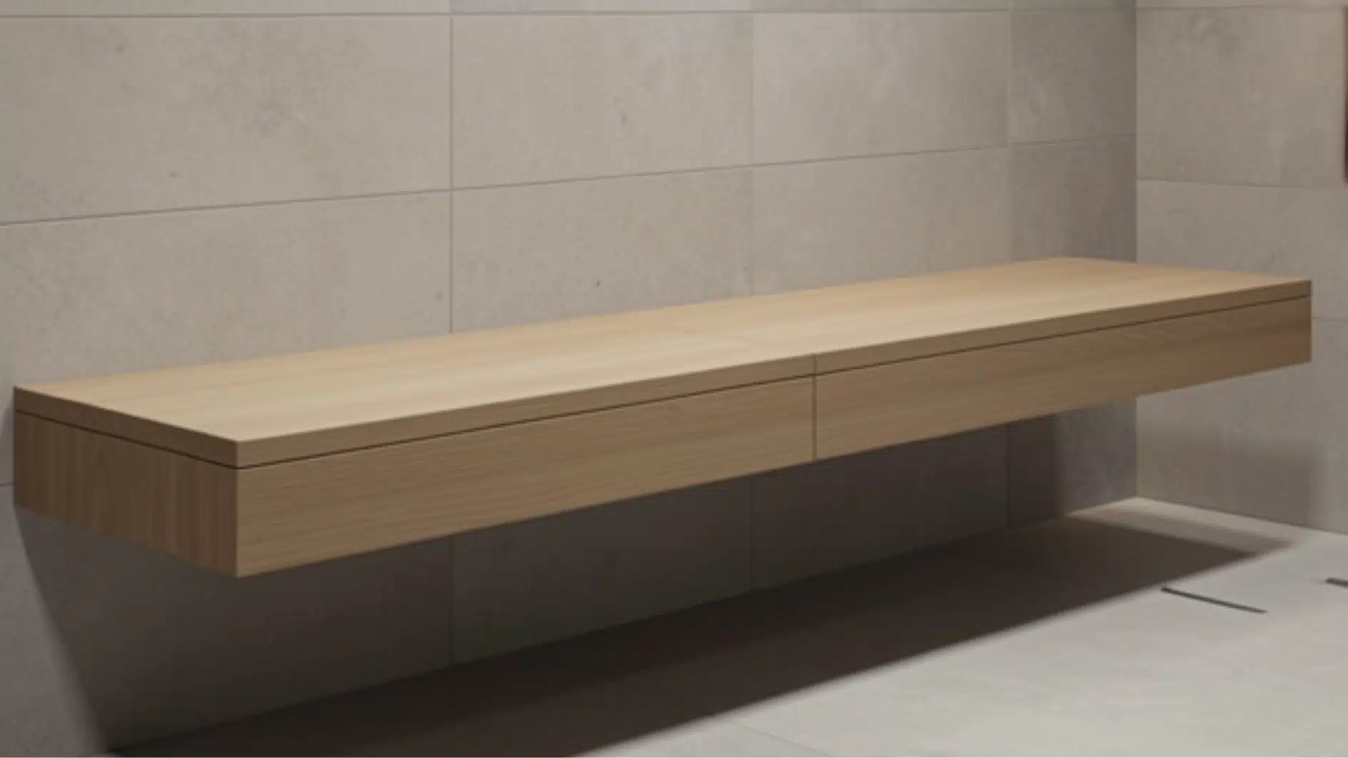 Minimalist light wood floating vanity with two drawers mounted against large, light grey tiled walls.